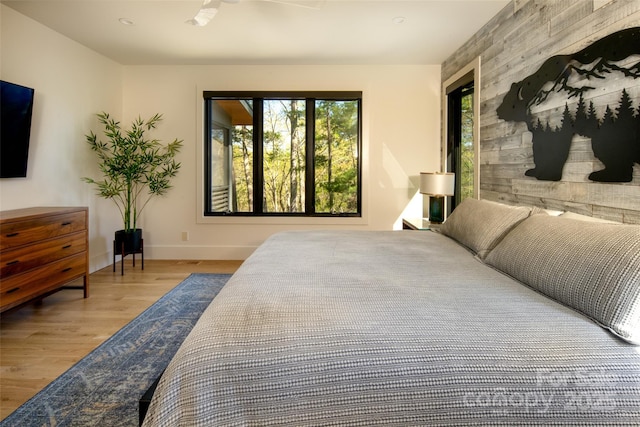 bedroom featuring wood finished floors and baseboards