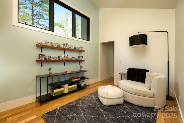 living area with light wood finished floors and baseboards