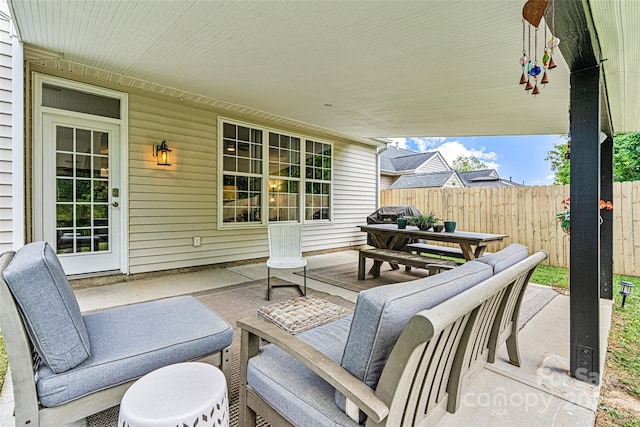 view of patio featuring fence and outdoor dining area