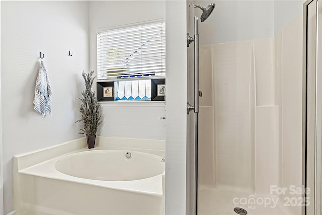 bathroom with a bath and a stall shower