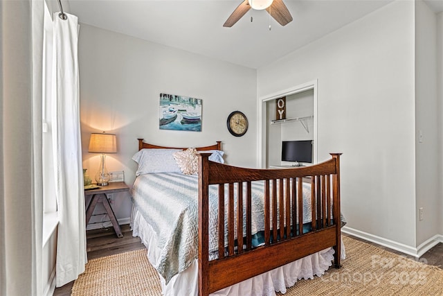 bedroom with baseboards, ceiling fan, and wood finished floors