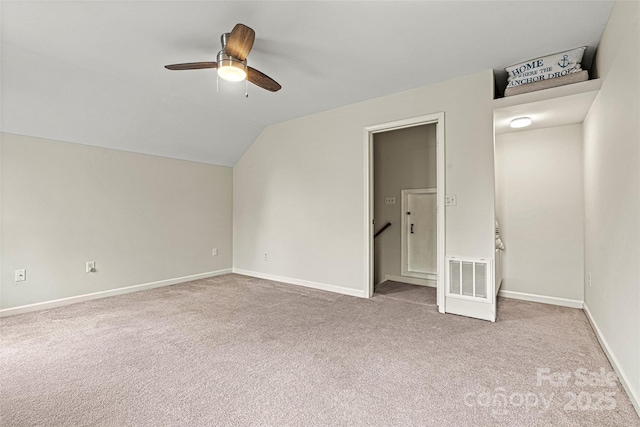 unfurnished bedroom featuring carpet flooring, baseboards, visible vents, and lofted ceiling
