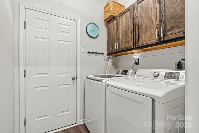laundry area with dark wood-type flooring, cabinet space, and independent washer and dryer