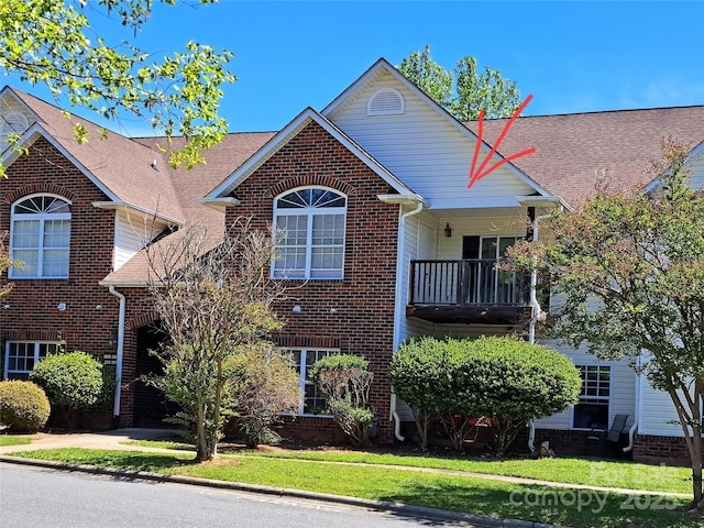 2527 Carya Pond Ln, Charlotte, NC 28212 - view of front of house with a front yard, brick siding, and a balcony