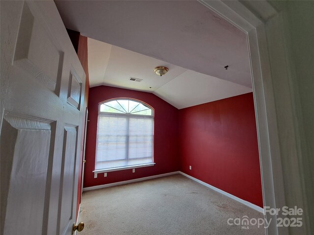 2527 Carya Pond Ln, Charlotte, NC 28212 - additional living space with visible vents, baseboards, carpet, and vaulted ceiling