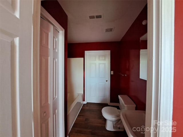 2527 Carya Pond Ln, Charlotte, NC 28212 - full bathroom featuring toilet, wood finished floors, a tub to relax in, and visible vents