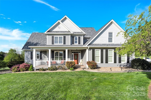 view of front of property with a front lawn, a porch, and a shingled roof