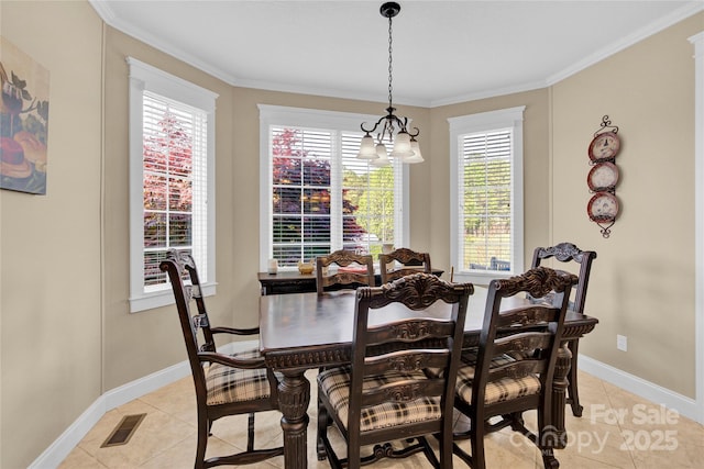 dining room featuring baseboards, ornamental molding, light tile patterned flooring, and visible vents