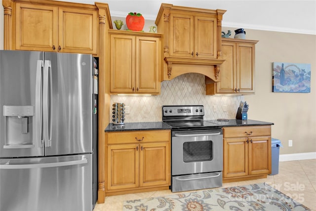 kitchen with ornamental molding, decorative backsplash, appliances with stainless steel finishes, and dark stone countertops