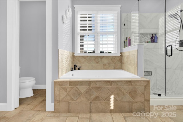 bathroom with baseboards, toilet, and a stall shower