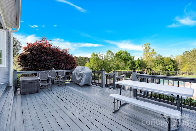 deck featuring grilling area and outdoor dining space