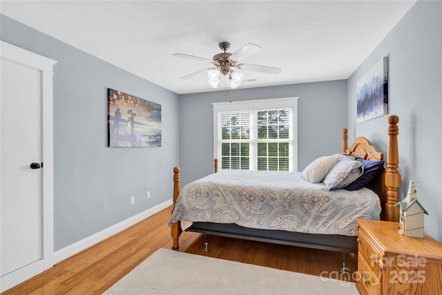 bedroom with baseboards, a ceiling fan, and wood finished floors