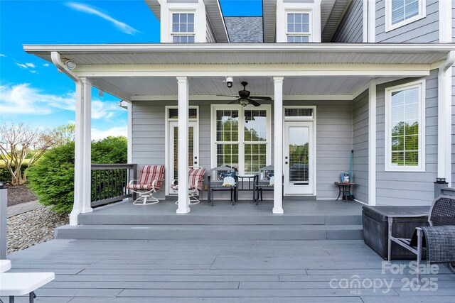 wooden deck with a ceiling fan