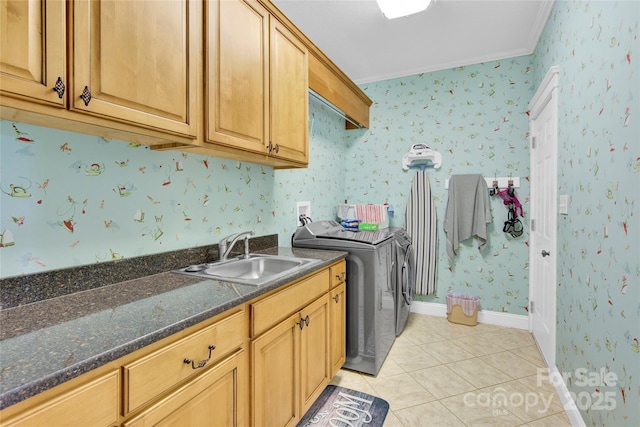 laundry area featuring washer and clothes dryer, a sink, light tile patterned flooring, cabinet space, and ornamental molding