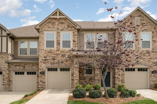 5684 Garrow Glen Rd Unit 96, Charlotte, NC 28278 - townhome / multi-family property with driveway, stone siding, a garage, and a shingled roof