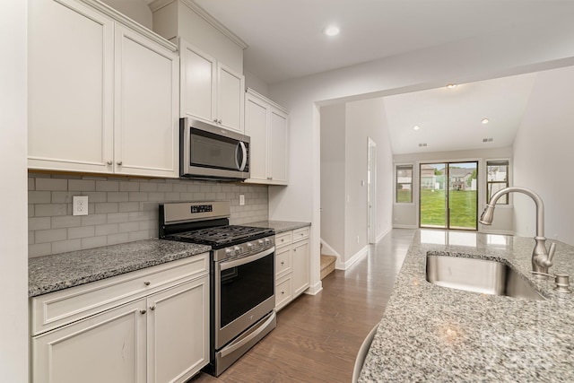 5684 Garrow Glen Rd Unit 96, Charlotte, NC 28278 - kitchen with tasteful backsplash, white cabinets, a sink, appliances with stainless steel finishes, and light stone countertops