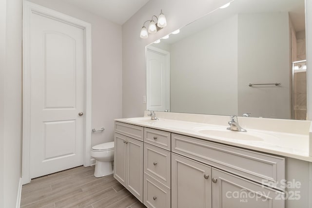 5684 Garrow Glen Rd Unit 96, Charlotte, NC 28278 - bathroom with toilet, double vanity, a sink, and wood finished floors