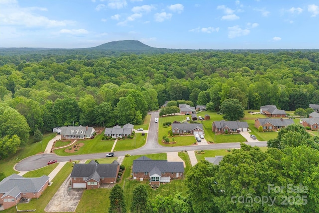 drone / aerial view with a forest view and a residential view