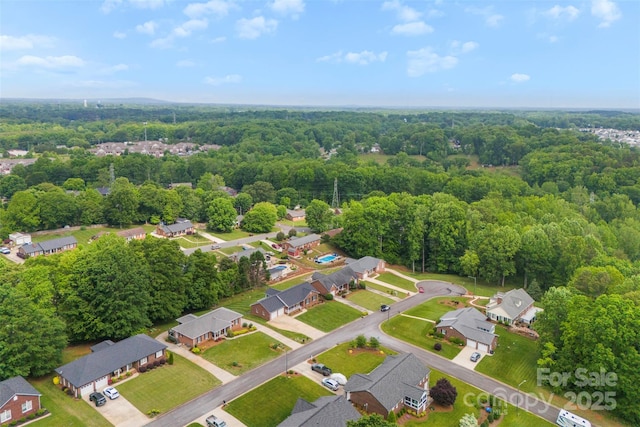 aerial view featuring a forest view and a residential view