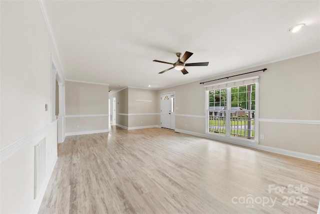spare room featuring a ceiling fan, baseboards, visible vents, and light wood-type flooring
