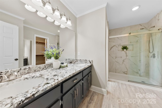 full bath featuring a marble finish shower, baseboards, and a sink