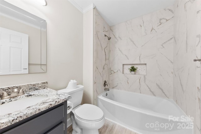 full bath featuring shower / tub combination, toilet, wood finished floors, vanity, and crown molding