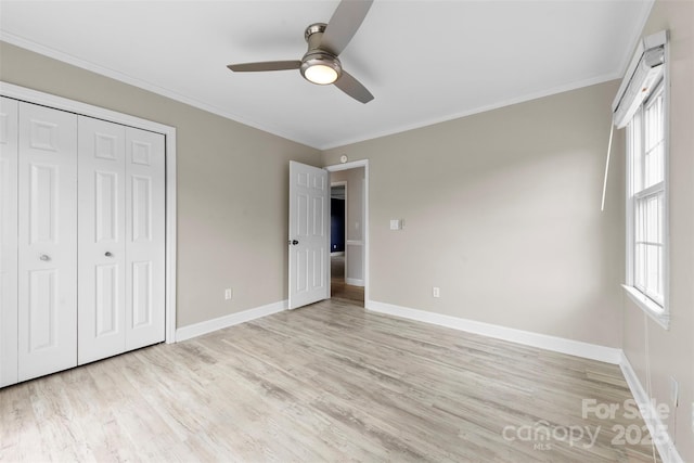 unfurnished bedroom with baseboards, ornamental molding, and light wood finished floors