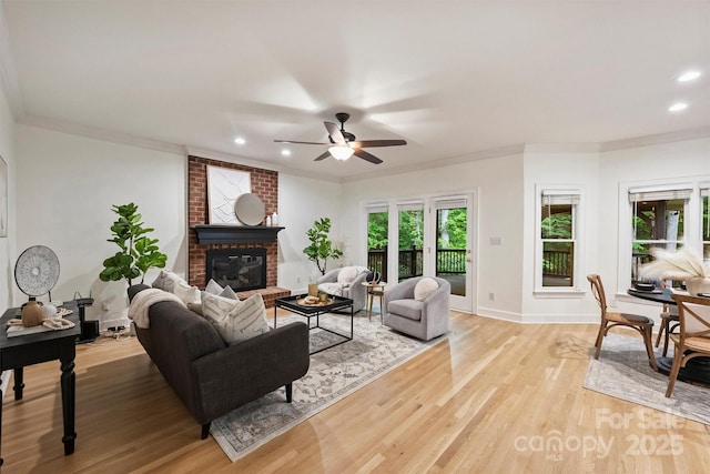 7067 Rocky Falls Rd, Charlotte, NC 28211 - living room featuring a brick fireplace, ceiling fan, ornamental molding, light wood-style floors, and recessed lighting