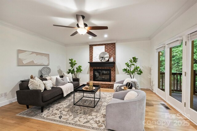 7067 Rocky Falls Rd, Charlotte, NC 28211 - living area with light wood-type flooring, crown molding, a ceiling fan, a fireplace, and baseboards