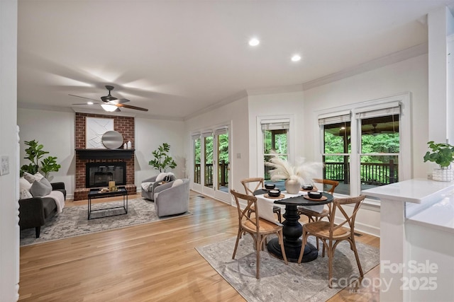 7067 Rocky Falls Rd, Charlotte, NC 28211 - dining space featuring ornamental molding, a brick fireplace, ceiling fan, light wood finished floors, and recessed lighting