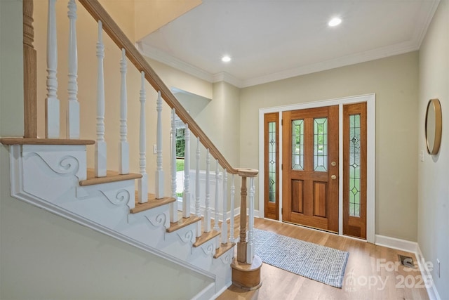 7067 Rocky Falls Rd, Charlotte, NC 28211 - foyer entrance featuring healthy amount of natural light, wood finished floors, stairway, recessed lighting, and ornamental molding
