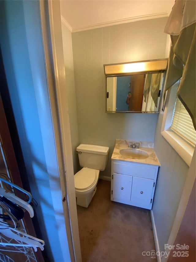 bathroom with baseboards, ornamental molding, toilet, and vanity