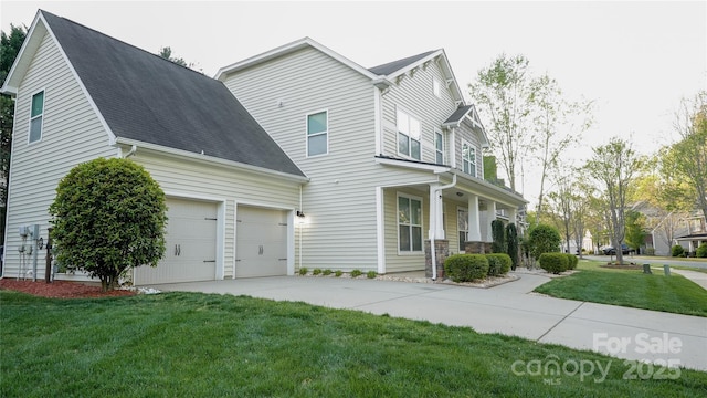 view of front of home with concrete driveway, a front yard, and an attached garage