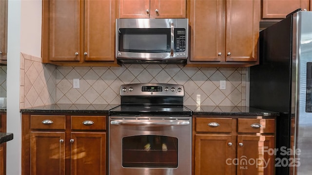 kitchen with brown cabinetry, decorative backsplash, and appliances with stainless steel finishes