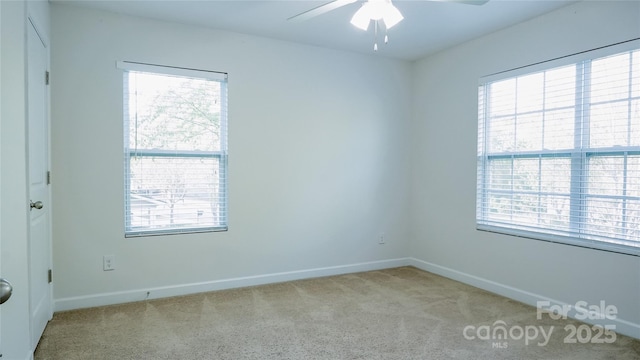 carpeted empty room with ceiling fan, baseboards, and a healthy amount of sunlight