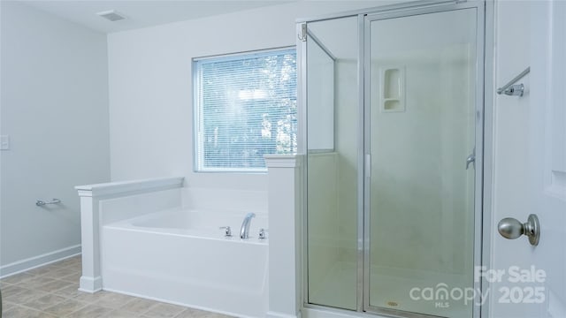 full bathroom with a shower stall, a bath, baseboards, and visible vents