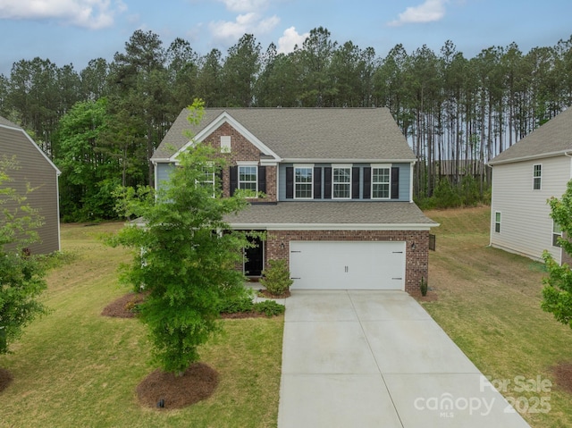 view of front of property with brick siding, a front lawn, an attached garage, and driveway