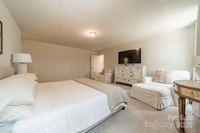 bedroom featuring light colored carpet