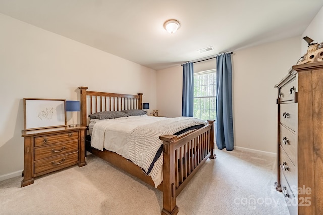 bedroom with light colored carpet, visible vents, and baseboards