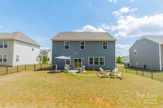 rear view of house featuring a lawn, central air condition unit, a patio, and a fenced backyard