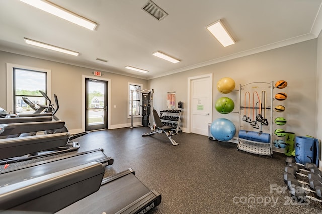 workout area featuring crown molding, baseboards, and visible vents