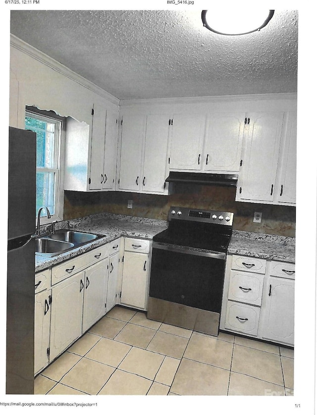 2831 Denview Ln, Charlotte, NC 28208 - kitchen featuring electric stove, exhaust hood, freestanding refrigerator, a textured ceiling, and light tile patterned floors
