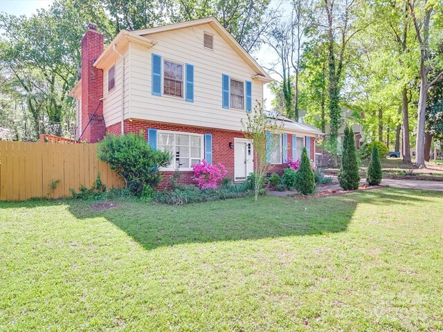 6820 Elm Forest Dr, Charlotte, NC 28212 - view of front of property featuring fence, brick siding, a chimney, and a front lawn