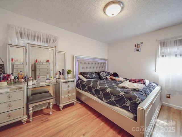 6820 Elm Forest Dr, Charlotte, NC 28212 - bedroom with light wood-style flooring, a textured ceiling, and baseboards