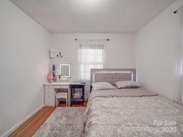 6820 Elm Forest Dr, Charlotte, NC 28212 - bedroom with baseboards, light wood-style floors, and a textured ceiling