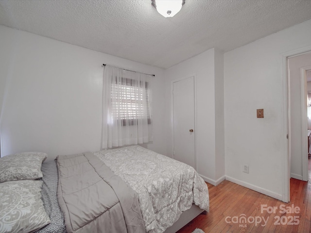 6820 Elm Forest Dr, Charlotte, NC 28212 - bedroom featuring baseboards, a textured ceiling, and hardwood / wood-style floors
