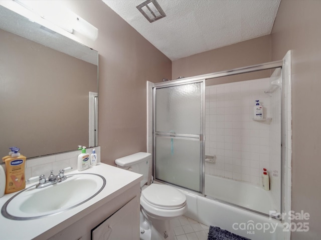 6820 Elm Forest Dr, Charlotte, NC 28212 - full bath featuring combined bath / shower with glass door, vanity, tile patterned floors, a textured ceiling, and toilet