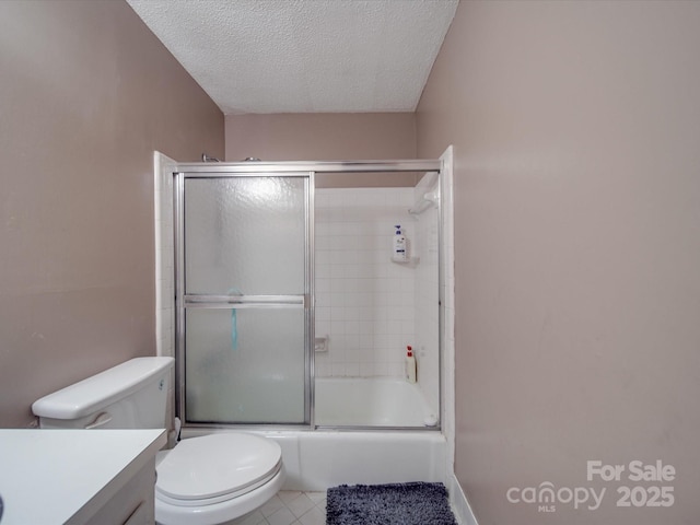 6820 Elm Forest Dr, Charlotte, NC 28212 - bathroom with vanity, tile patterned floors, a textured ceiling, toilet, and bath / shower combo with glass door