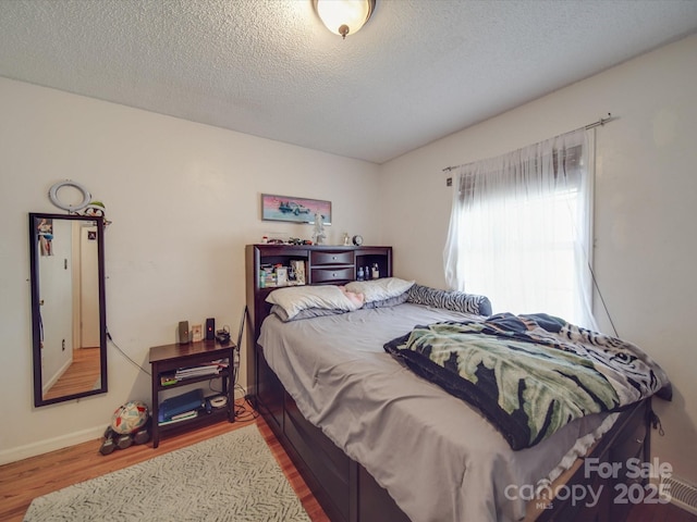 6820 Elm Forest Dr, Charlotte, NC 28212 - bedroom featuring a textured ceiling, wood finished floors, and baseboards
