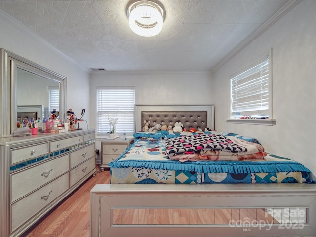 6820 Elm Forest Dr, Charlotte, NC 28212 - bedroom featuring crown molding, visible vents, and light wood-style floors